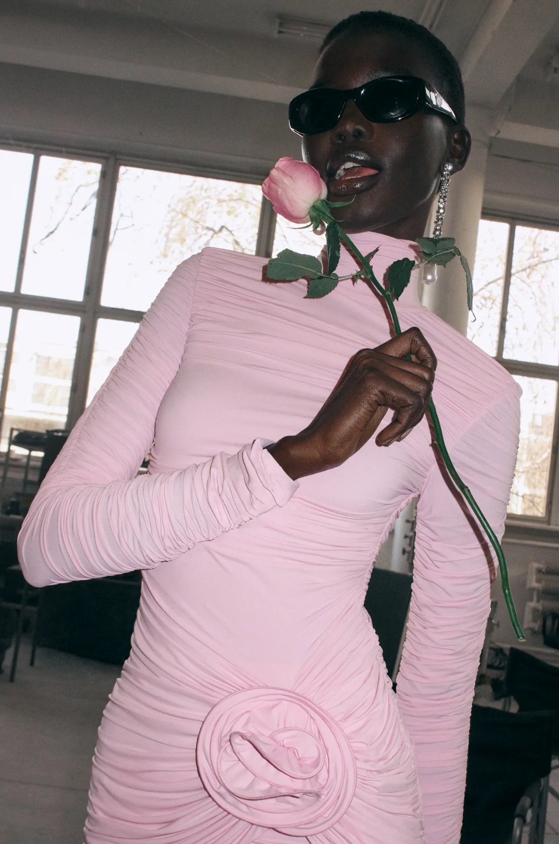 Close-up of Magda Butrym's signature hand-sculpted 3D silk rose appliqué.
