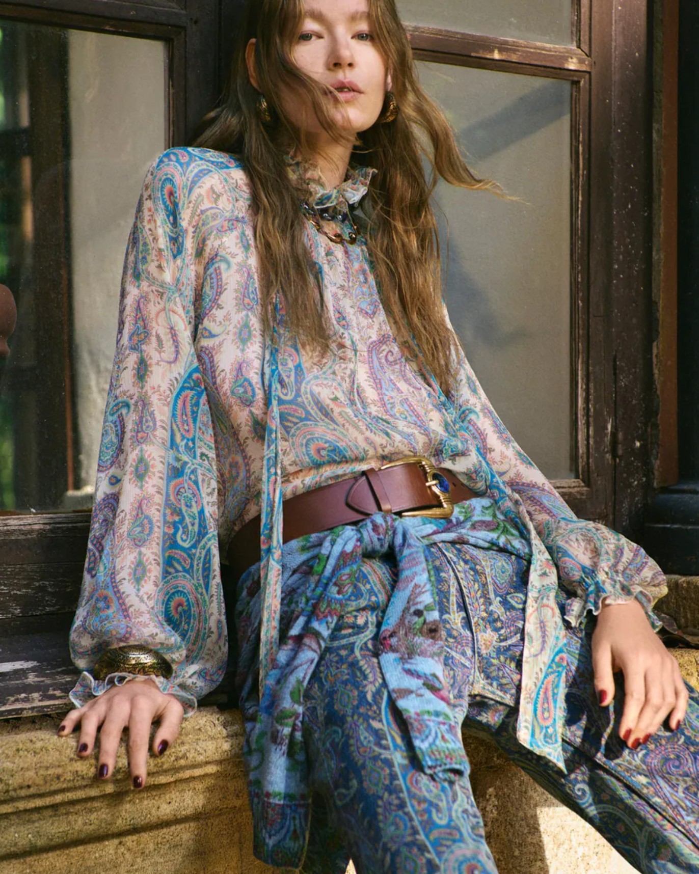 Runway look from the Etro collection showcasing bohemian tailoring and layered prints.