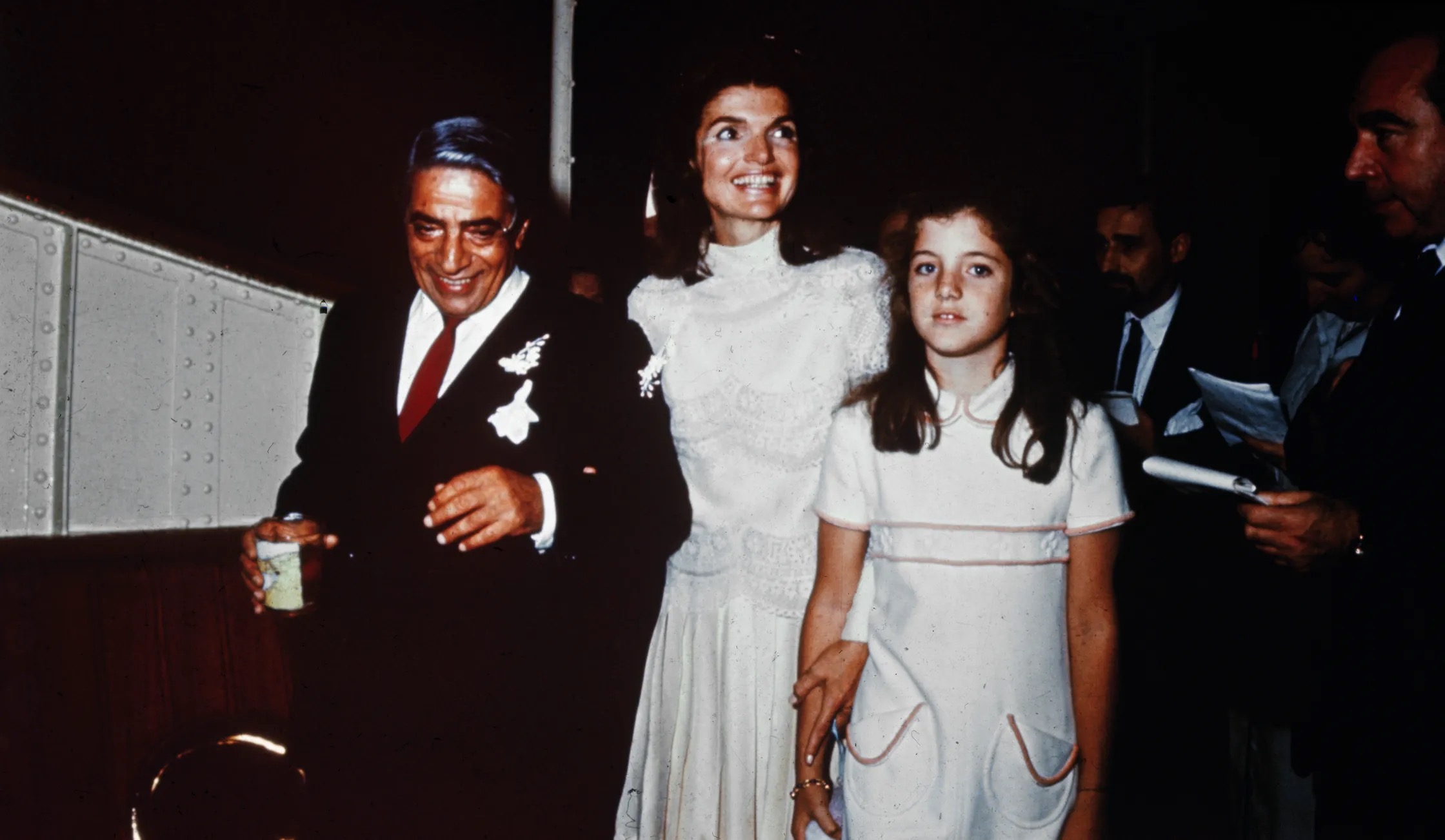 Aristotle Onassis and his new wife, Jacqueline Kennedy with her daughter Caroline, walk back to his Yacht after their wedding on Scorpios Island, 1986