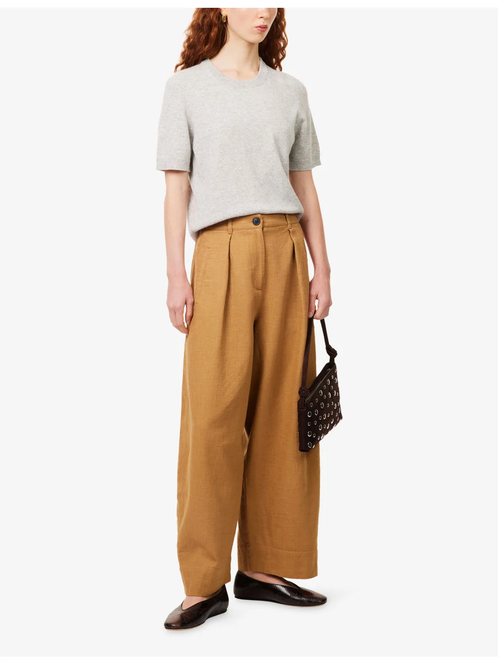 A model wearing the fluid, crease-resistant ME+EM Pleated Wide-Leg Trouser in a dark neutral shade.