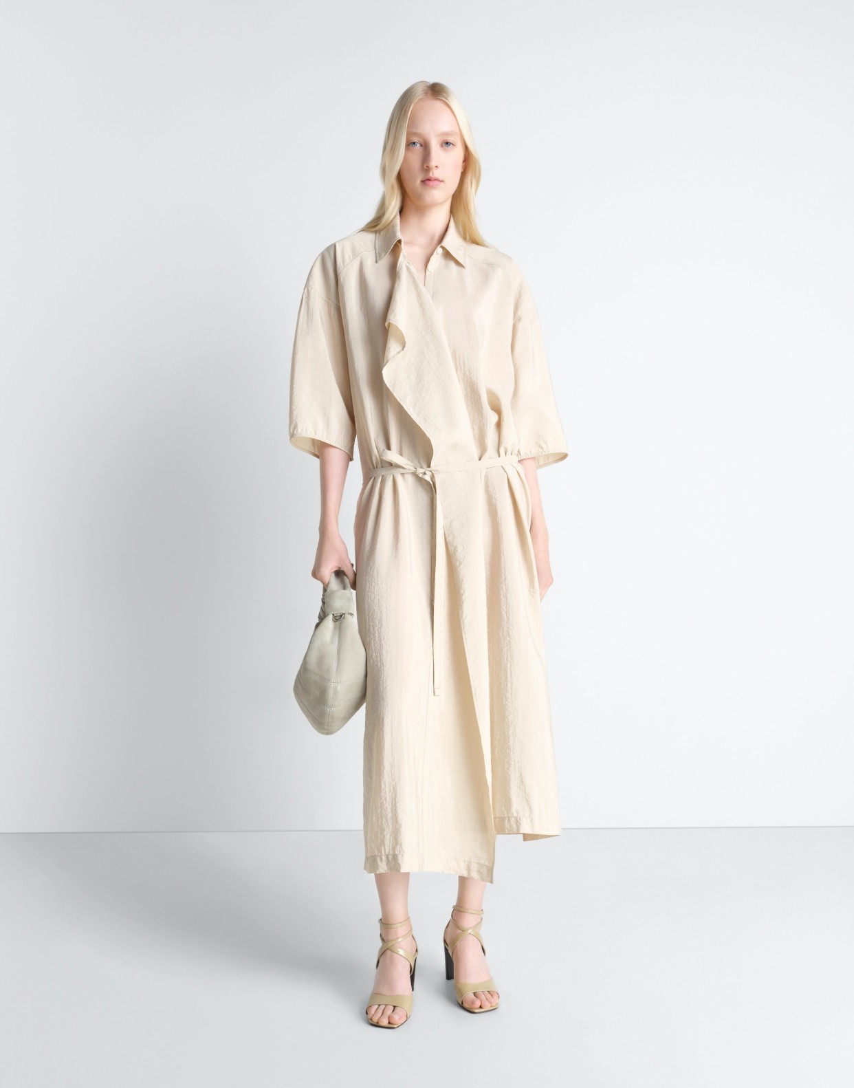 A relaxed styling of the cream Lemaire Asymmetrical Shirt Dress in lightweight Dry Silk.