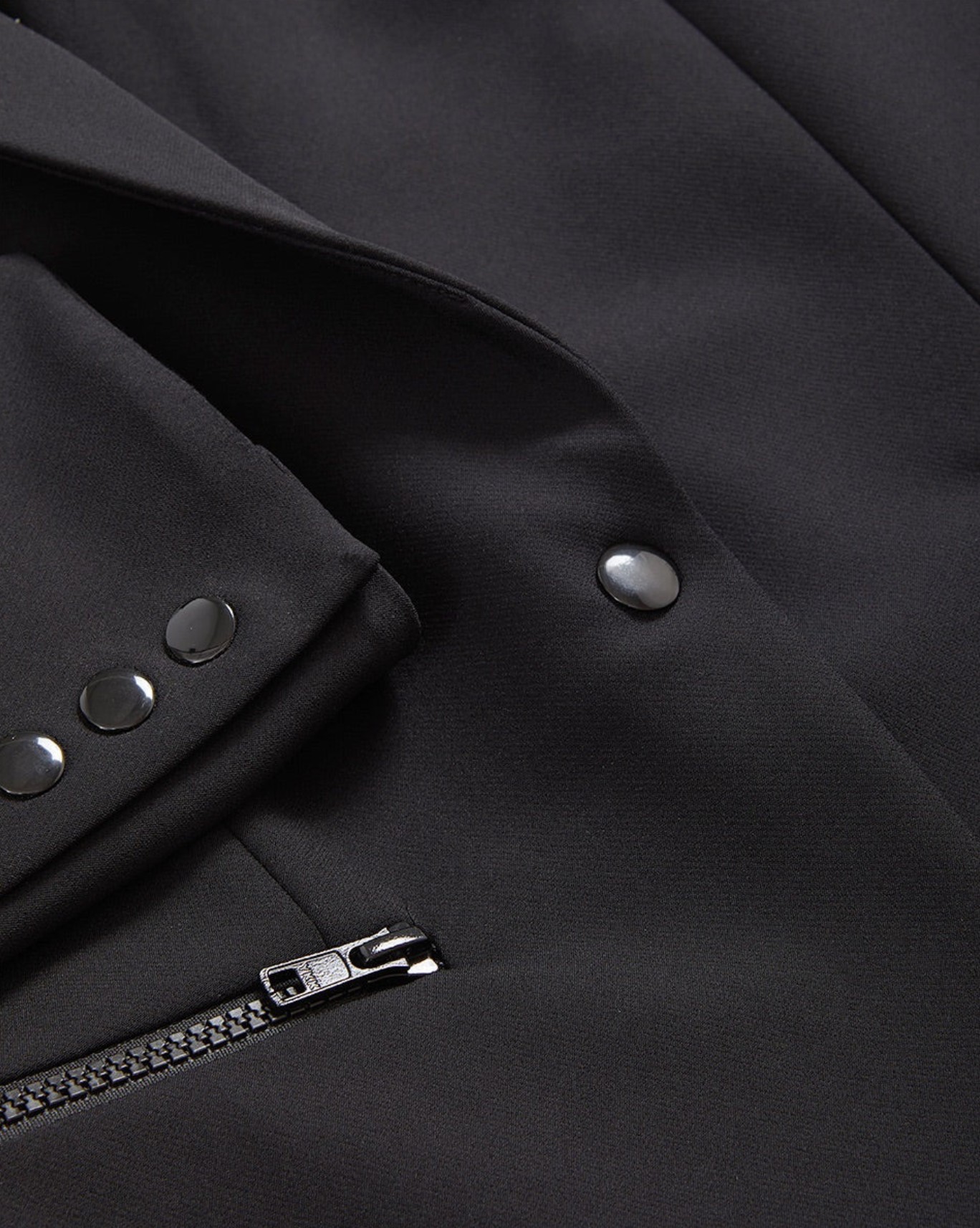 Close-up of the wrinkle-resistant stretch nylon fabric and zip details on the Veronica Beard Scuba Blazer.
